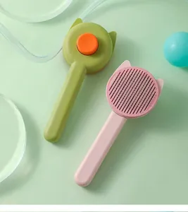 Detailed macro view of cat-ear shaped pet grooming brushes in pink and green colors.