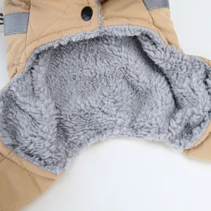 Close-up detail of thick grey fleece lining and khaki quilted fabric on dog winter coat