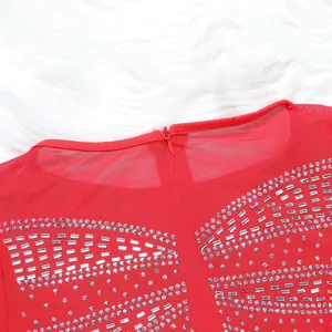 Close-up detail of red mesh party dress with sparkling rhinestones and zipper
