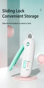 Close-up detail of white and green adjustable pet nail clipper featuring sliding lock mechanism
