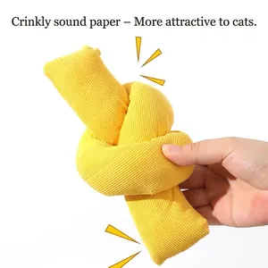 Yellow knotted plush cat toy with built-in crinkle paper for interactive sound play