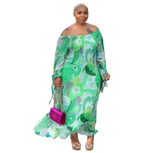 Detail of a green floral off-the-shoulder maxi dress with long sleeves and flowy fit.