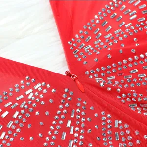 Detail of red mesh evening dress with sparkling rhinestones and hidden zipper
