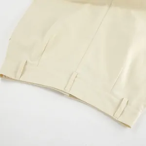 Close-up detail showing the waistline and belt loops of a beige high waist workwear skirt