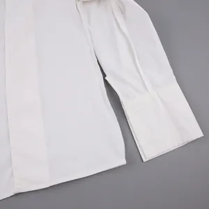 Detailed macro shot of white cotton French blouse sleeve cuff and side seam stitching