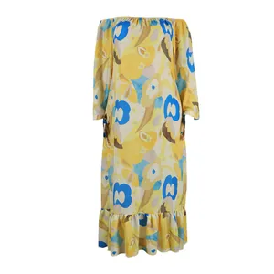 Detail view of the bold yellow and blue floral print on this off-shoulder maxi dress.