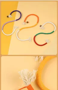 Detailed macro view of woven cotton rope cat toy with tassels and natural fruit