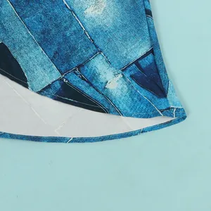 Detailed macro view of the blue abstract denim print hemline on a slim-fit fashion dress