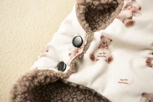 Macro view of dog vest featuring teddy bear print corduroy and warm sherpa lining