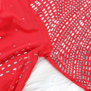 Close-up of red mesh dress with intricate silver rhinestone and baguette crystal patterns
