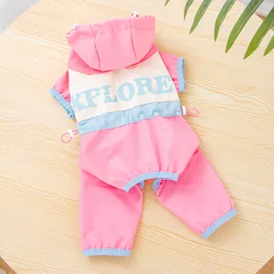 Detail view of a pink dog tracksuit with EXPLORE text print on the back