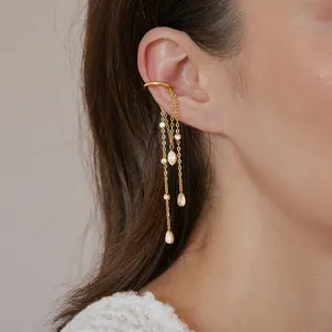 Detailed shot of gold stainless steel ear cuff with long water-drop chain tassels.