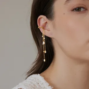 Close-up view of gold stainless steel ear cuff with teardrop zircon chain tassels