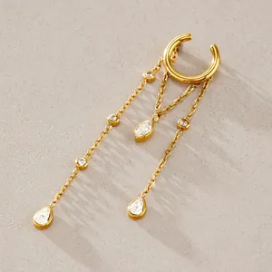 Close-up of gold stainless steel ear cuff with dangling chains and teardrop crystals