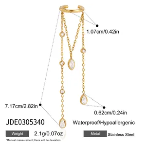 Detail view of gold stainless steel ear cuff with chain tassels and CZ teardrop stones