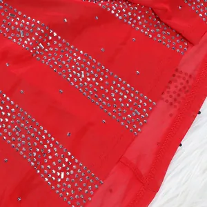 Close-up detail of red mesh evening gown featuring shimmering rhinestone stripe patterns