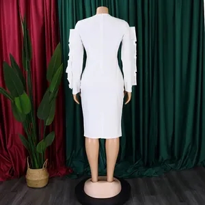 Back view of white elegant plus size long-sleeve dress with ruffled detail