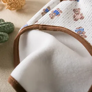 Close-up detail of the soft white fleece lining and cute bear print on a pet vest