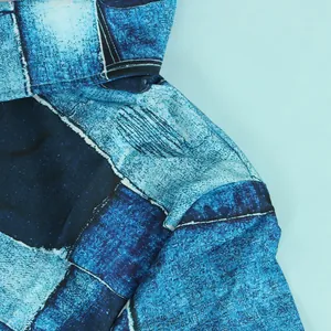 Close-up showing the intricate blue abstract patchwork fabric detail of this slim dress.