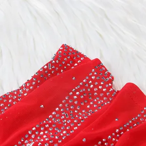 Macro detail view showing silver rhinestone patterns on a sexy red mesh maxi dress.