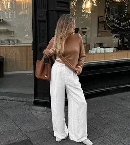 High-waisted white linen wide-leg trousers for a casual summer street style look