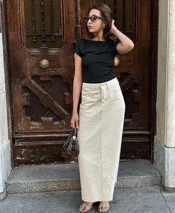 Full body shot of a stylish model wearing a chic beige high-waist straight denim maxi skirt