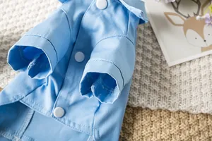 Vue détaillée de la veste en jean bleu clair pour animaux avec coutures et boutons