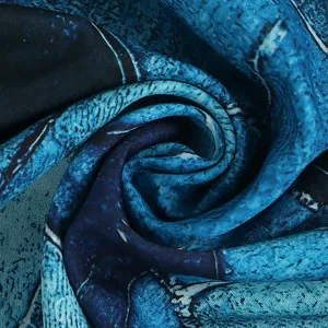 Macro view of the soft texture and blue abstract print on this nightclub dress fabric.