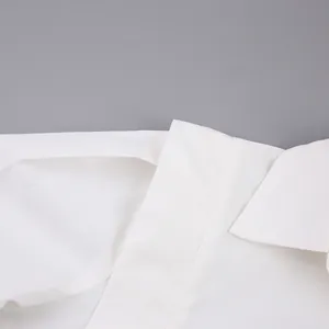 Detail view of the crisp white cotton collar and shoulder of a French style blouse