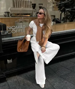 Stylish breathable white linen wide-leg trousers featured in a street style look