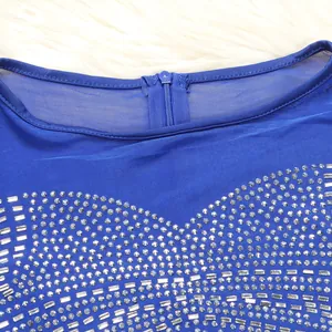 Detailed close-up of sparkling silver rhinestones on a royal blue sheer mesh evening dress