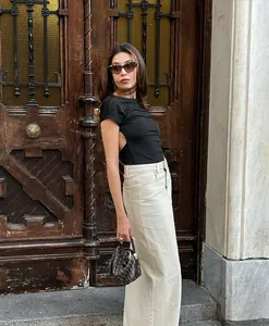 Lifestyle view of a French style high waist beige denim straight midi skirt outfit