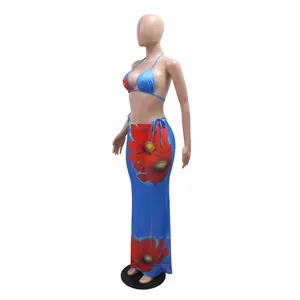 Elegant blue three-piece floral print bikini set with matching long mesh cover-up