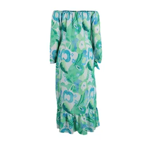Detailed view of the vibrant green floral print on this elegant off-shoulder maxi dress.