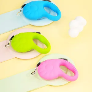 A detailed view showing three colorful pumpkin-shaped 5M automatic retractable dog leashes.