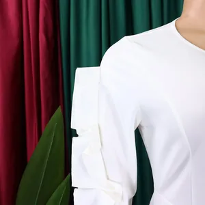 Detailed macro shot of the elegant white pleated ruffle sleeve on a woman's dress.