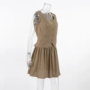 Side view of a khaki linen vest and pleated skirt set for women in French style.
