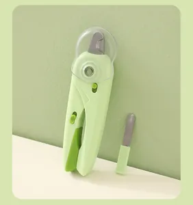 Close-up of light green pet nail clipper with LED light and integrated nail file