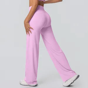 Detail shot of pink high-waisted flared yoga pants with loose breathable fabric.