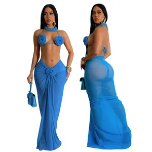 Detail of sexy blue three-piece bikini set featuring 3D floral design and mesh wrap skirt