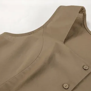 Detailed close-up view of khaki cotton linen vest showing the neckline and wooden buttons