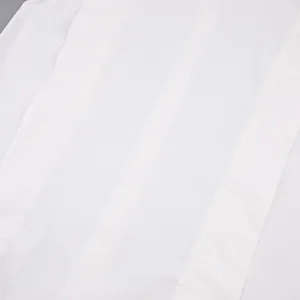 High-quality macro detail view of white cotton French style blouse showing clean stitched seams
