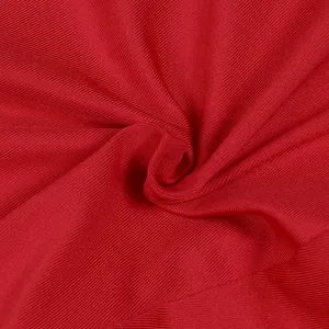 Macro close-up showing the fine ribbed texture of vibrant red evening dress fabric