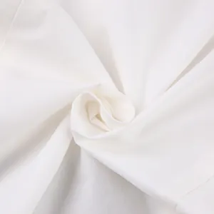 Close-up of high-quality white pure cotton fabric texture with soft folds and weave detail