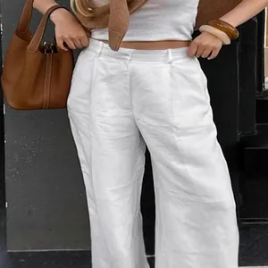 High-waisted white linen wide-leg pants for women in a chic summer street style