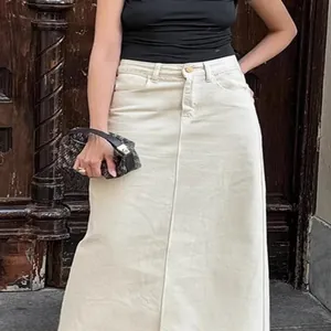 Elegant French style high-waisted beige denim maxi skirt with a straight silhouette