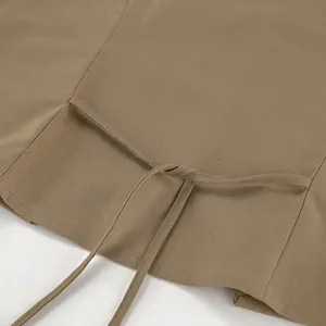 Close-up detail of khaki cotton linen vest set showing tie-back design and fabric texture
