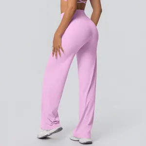 Close-up detail showing back view and flared leg of pink high-waisted yoga pants.