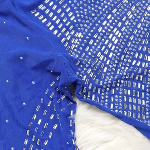 Detail of royal blue mesh dress featuring sparkling silver rhinestones and baguette crystals