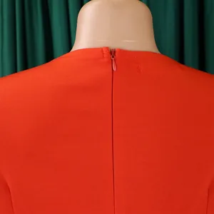 Macro view of the high-quality back hidden zipper on an elegant orange formal dress
